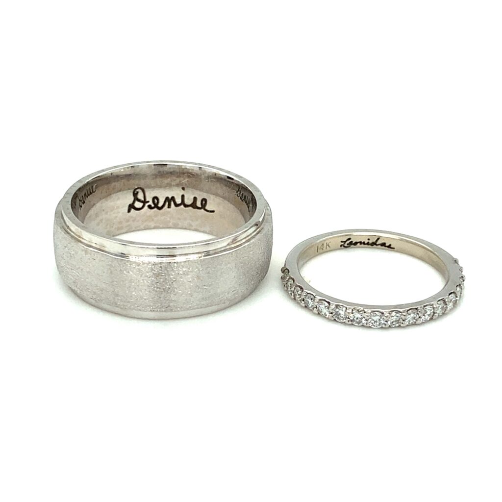 the name "Denise" engraved inside a wedding band next to a ring with the name "Leonidas" engraved inside