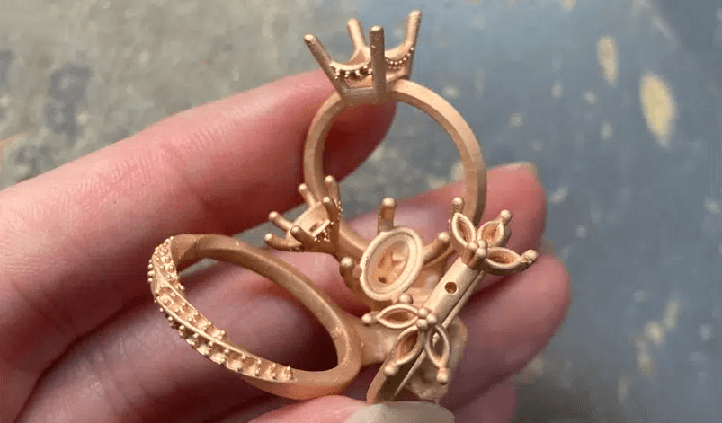 production casting of custom jewelry held in a hand